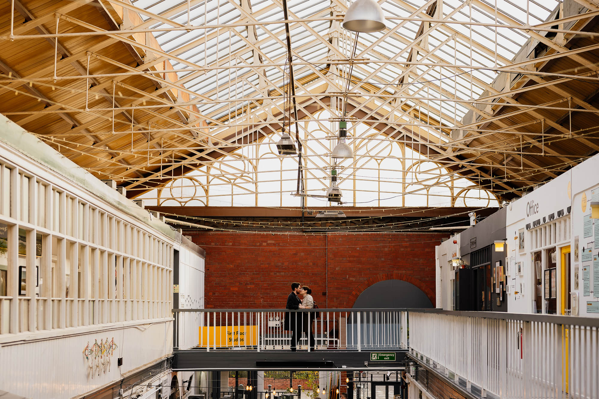 Couple stood on mezzanine walkway in Manchester Craft and Design Centre