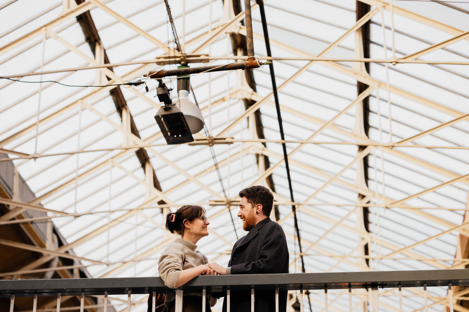 Couple stood on mezzanine walkway in Manchester Craft and Design Centre