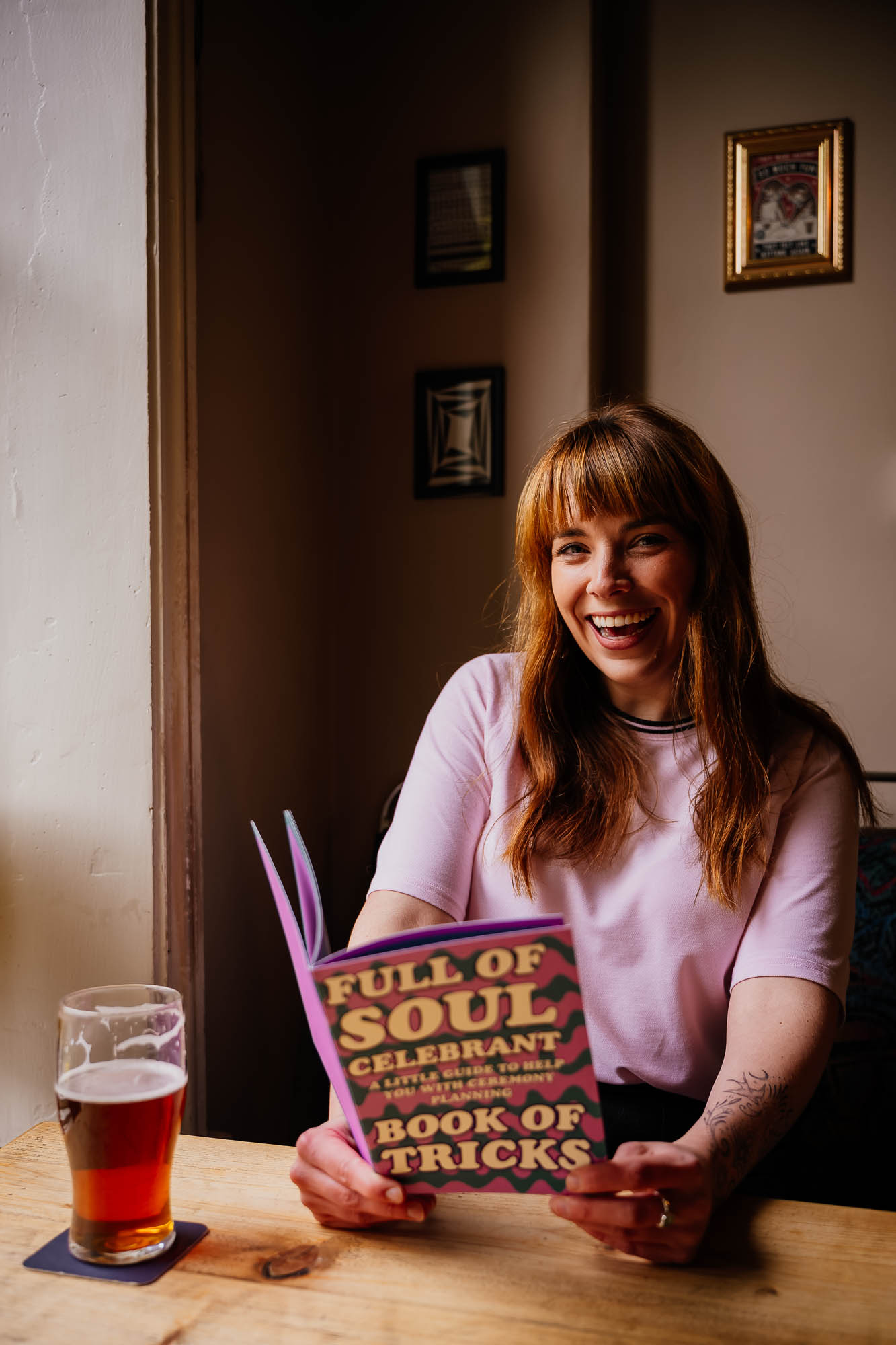 Woman holding business booklet and laughing