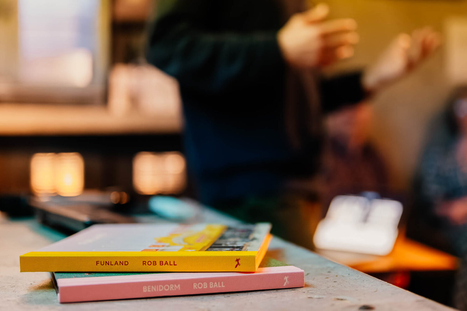Artists books on the table with hand gesturing