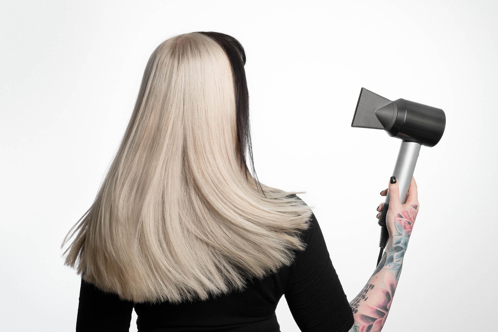 Woman holding hair dryer with hair swishing