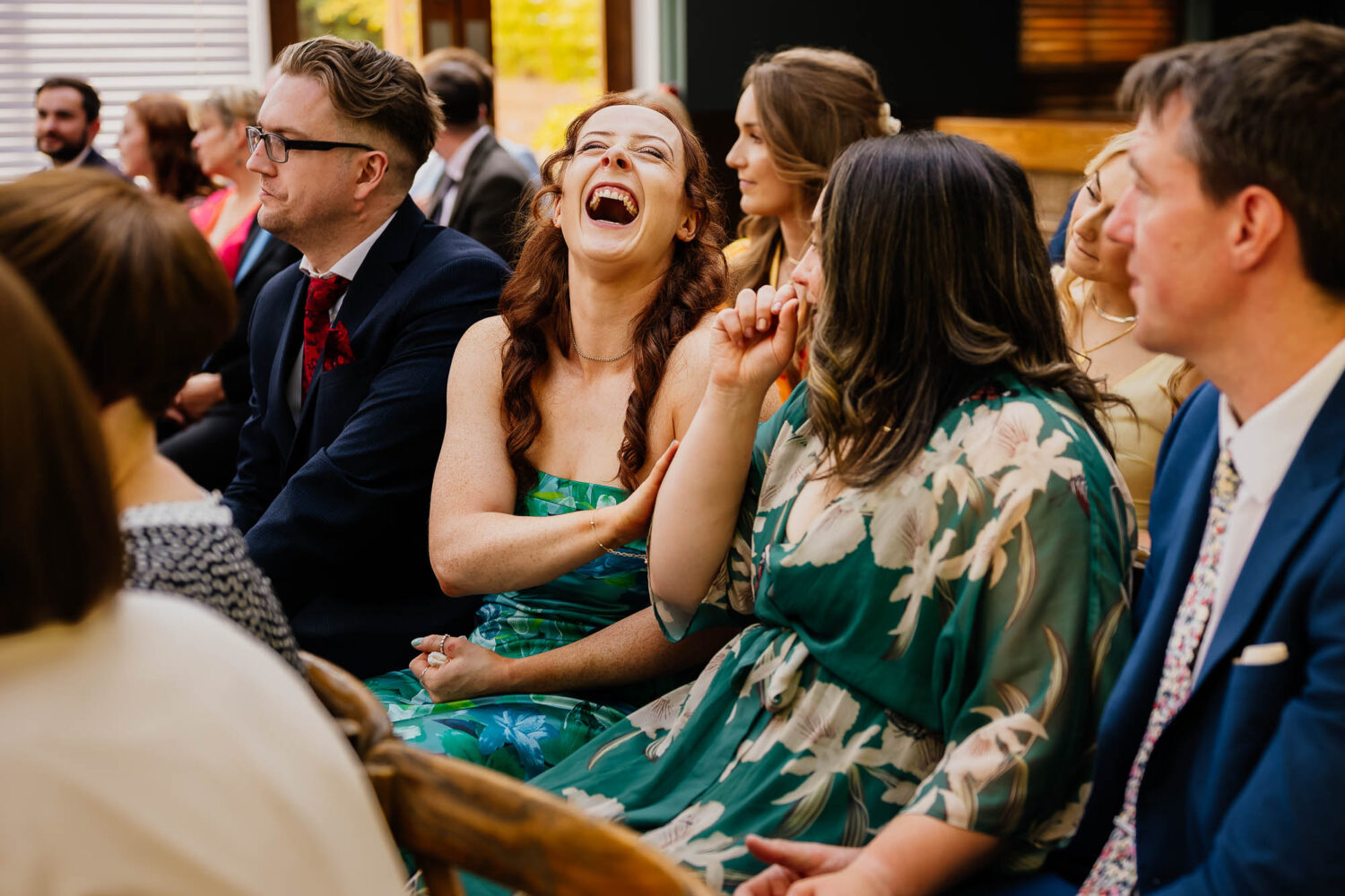 Woman laughing during wedding ceremony