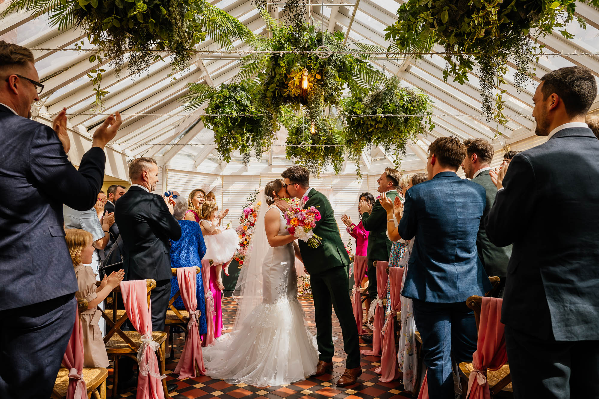 Couple kiss in the aisle at The Faversham