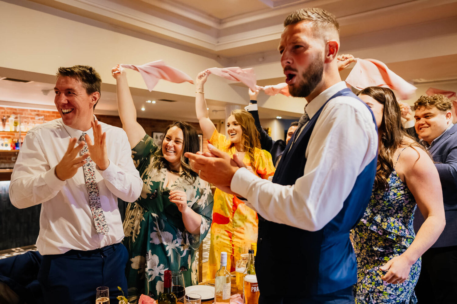 Guests cheering and waving napkins at The Faversham