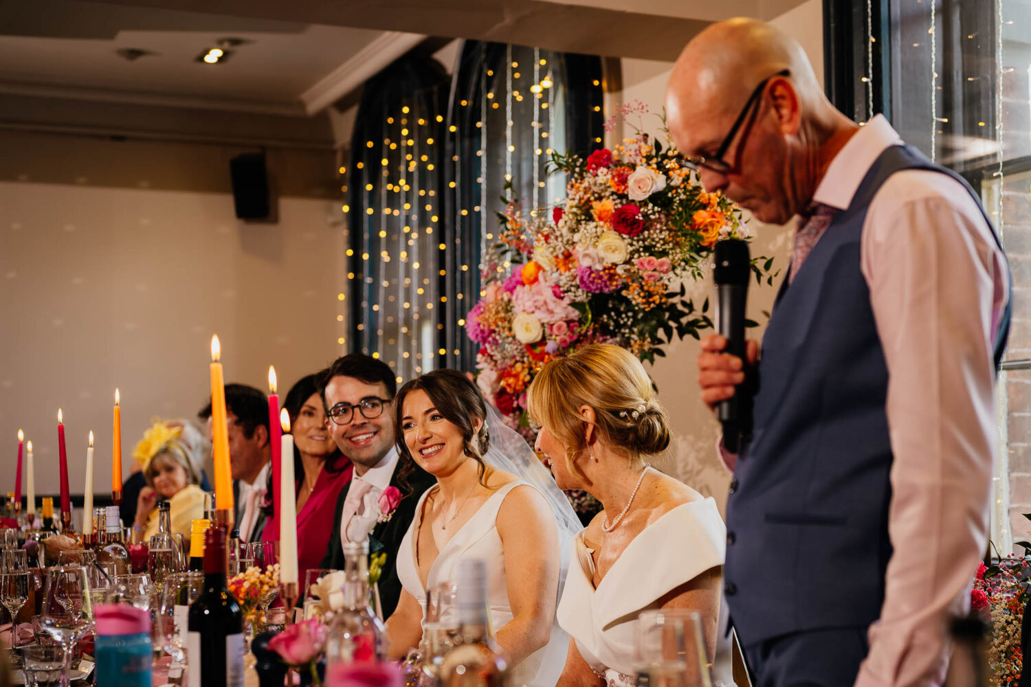 Bride smiling during father of the bride speech