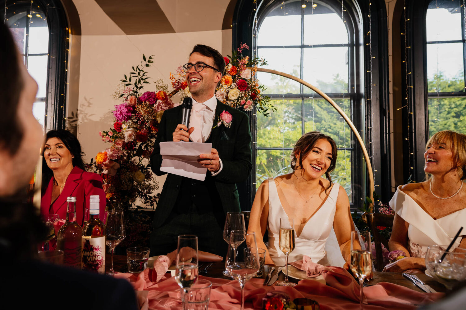 Groom speech with bride laughing