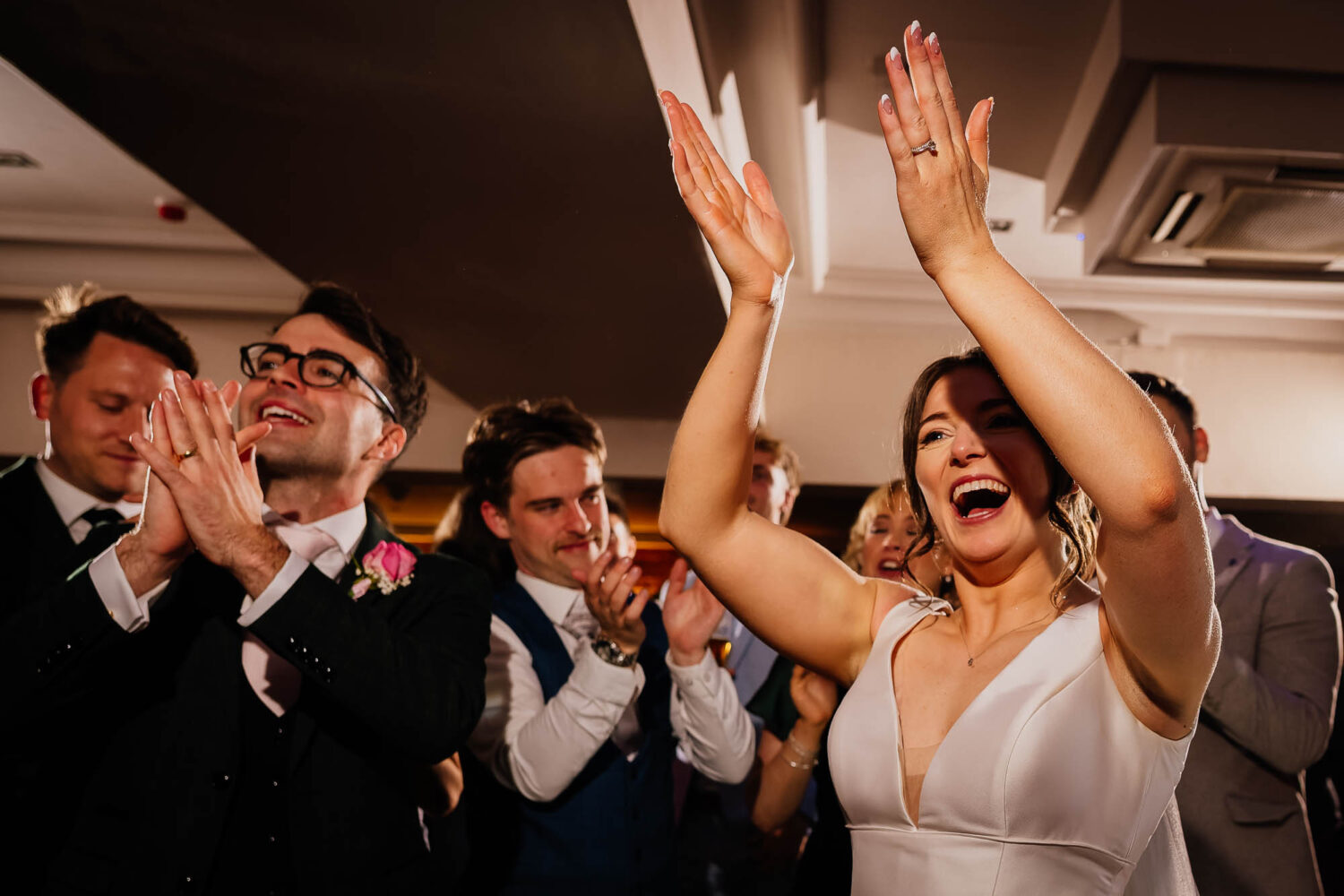 Bride clapping on the dancefloor at The Faversham wedding