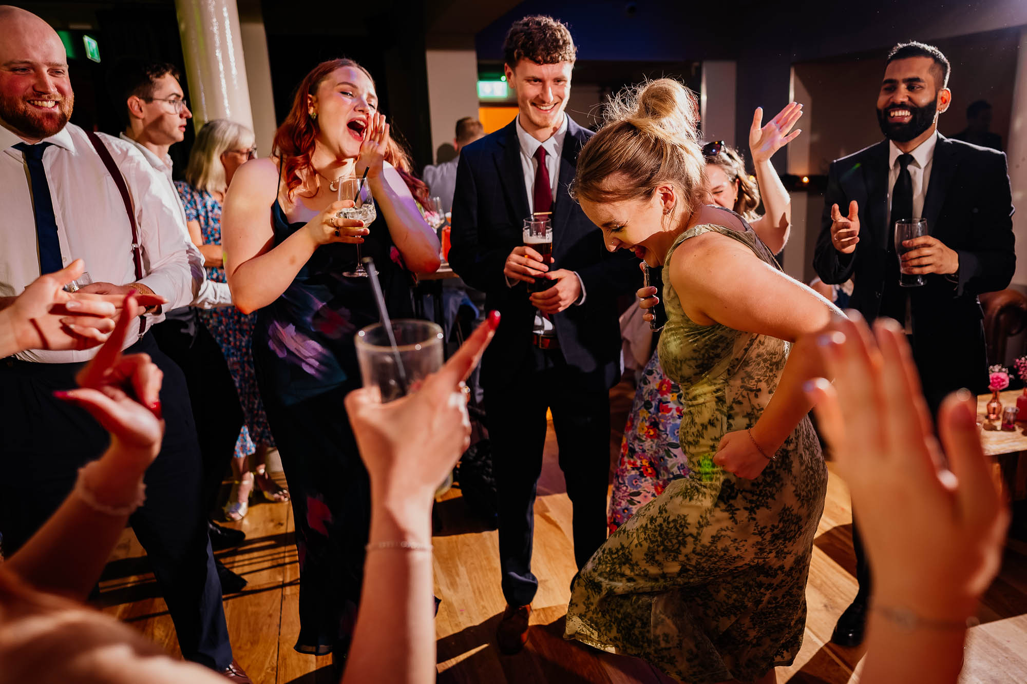 People cheering girl as she dances in the middle of a circle