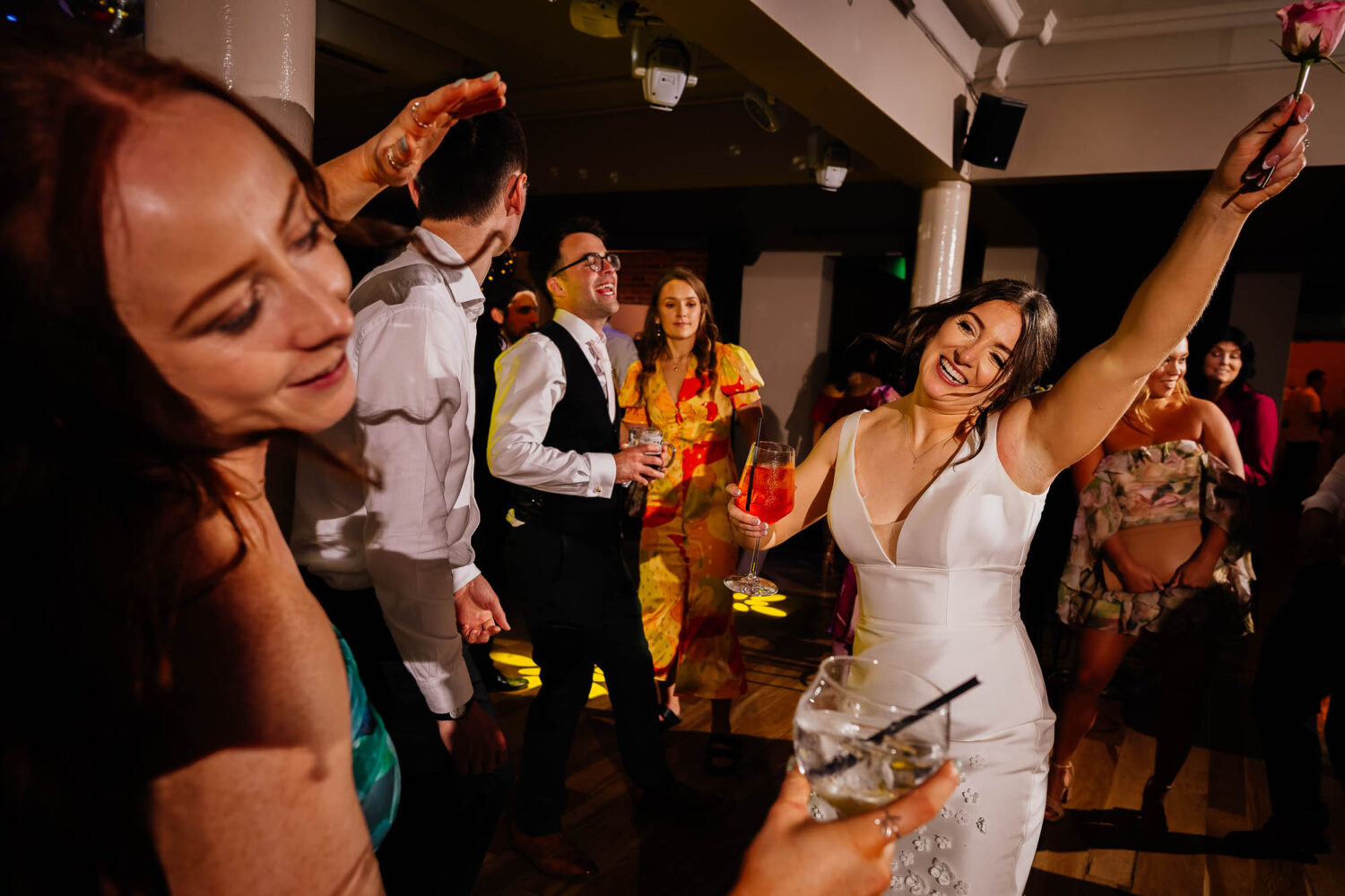 Bride holding flower and dancing