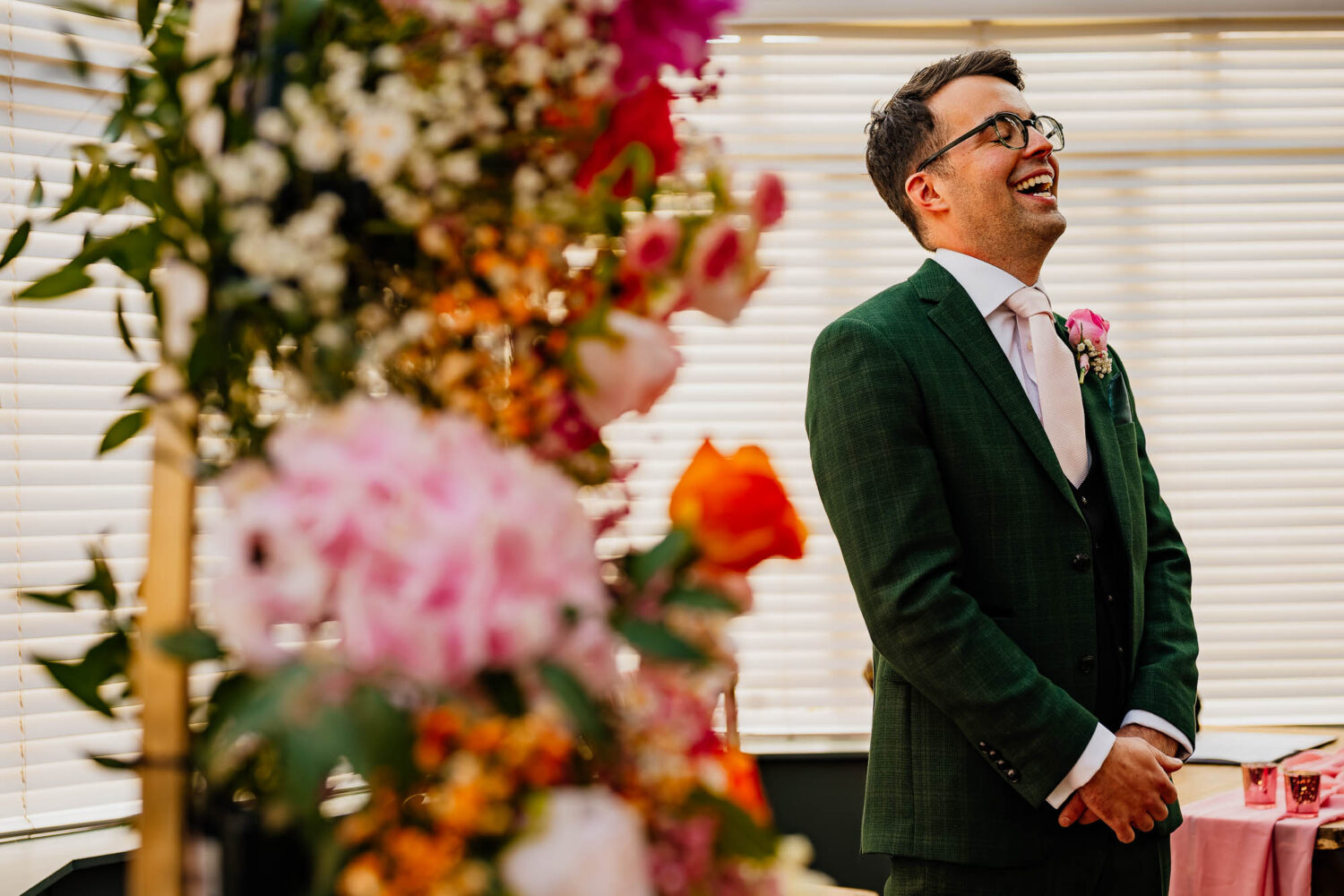 Groom laughing whilst waiting for the ceremony