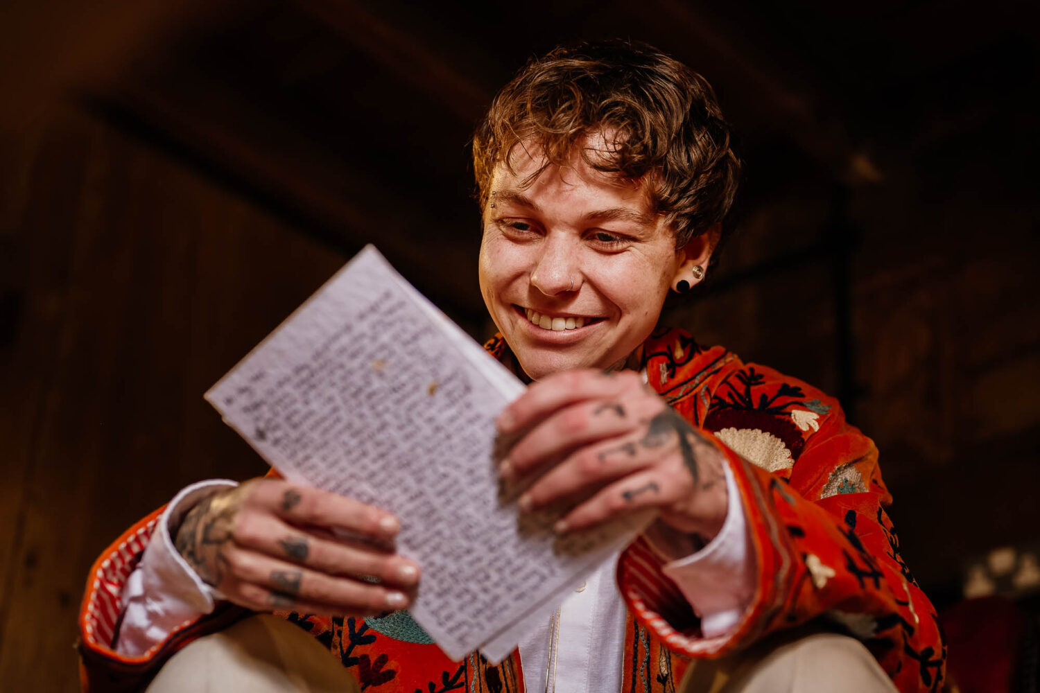 Groom reading card from bride
