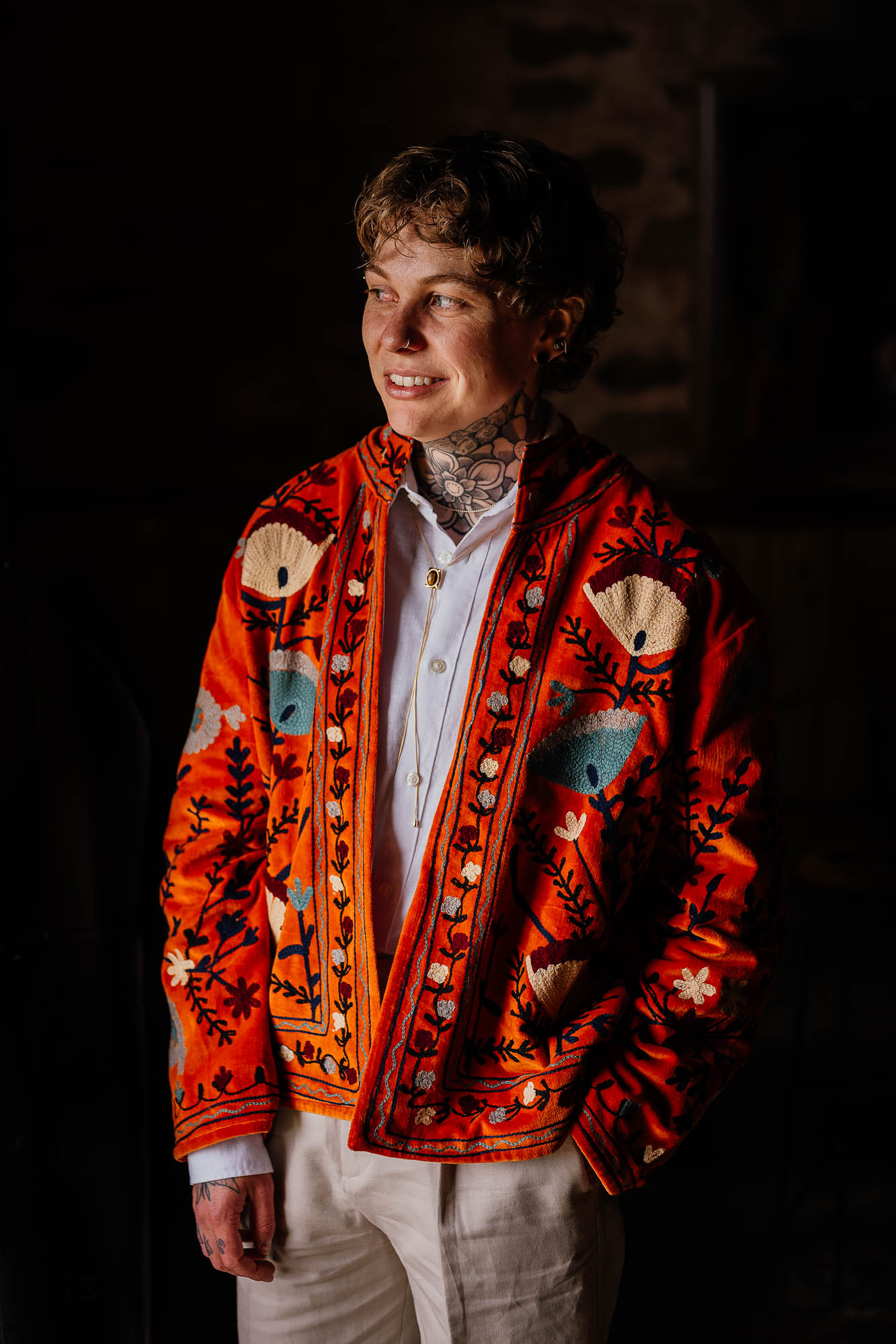 Moody portrait of man in orange embroidered jacket