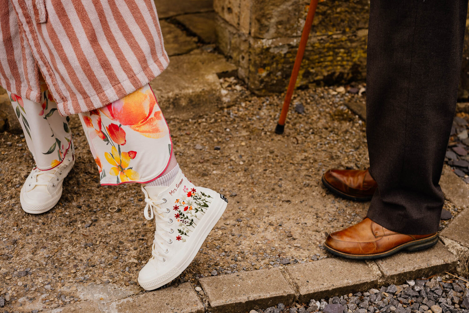 Showing off white converse embroidered with flowers to grandad