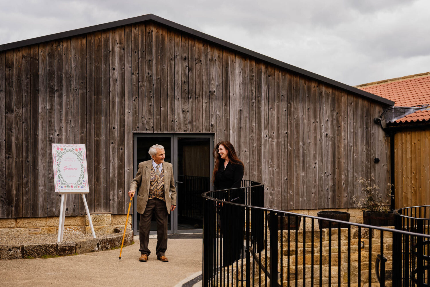 Danby wedding coordinator escorting grandad through the venue
