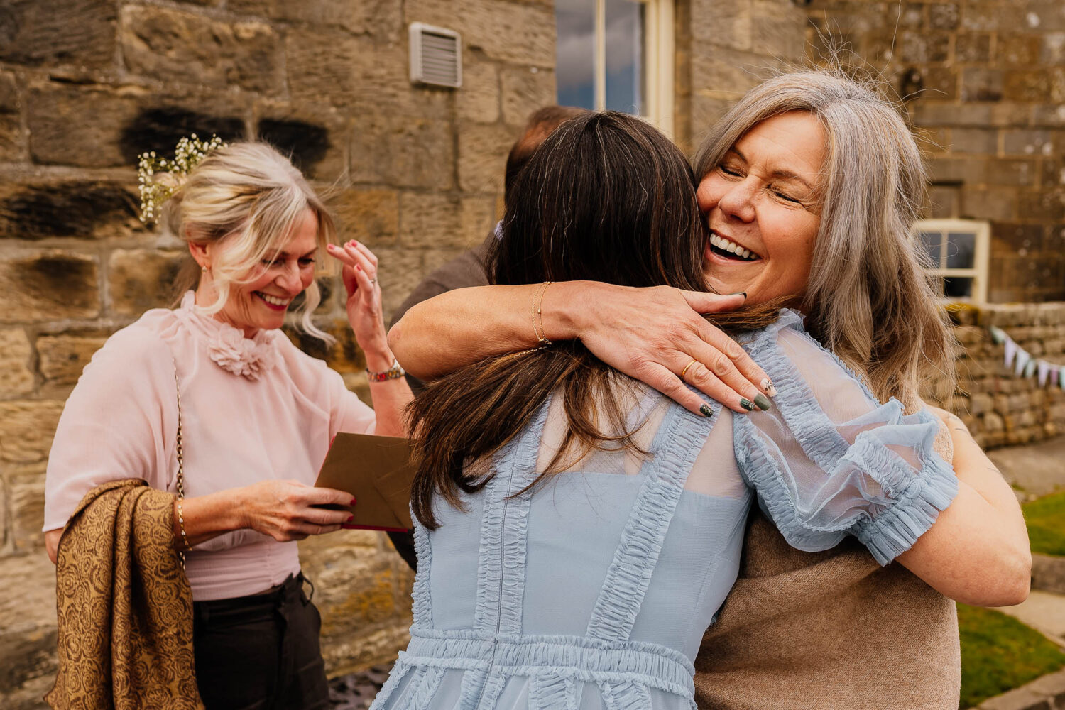 Women hugging outside Danby Castle