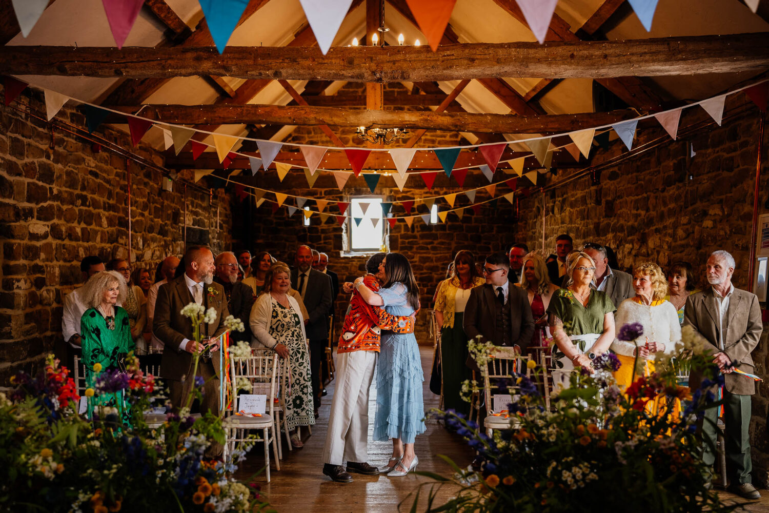 Groom and mum hugging in the aisle at Danby Castle