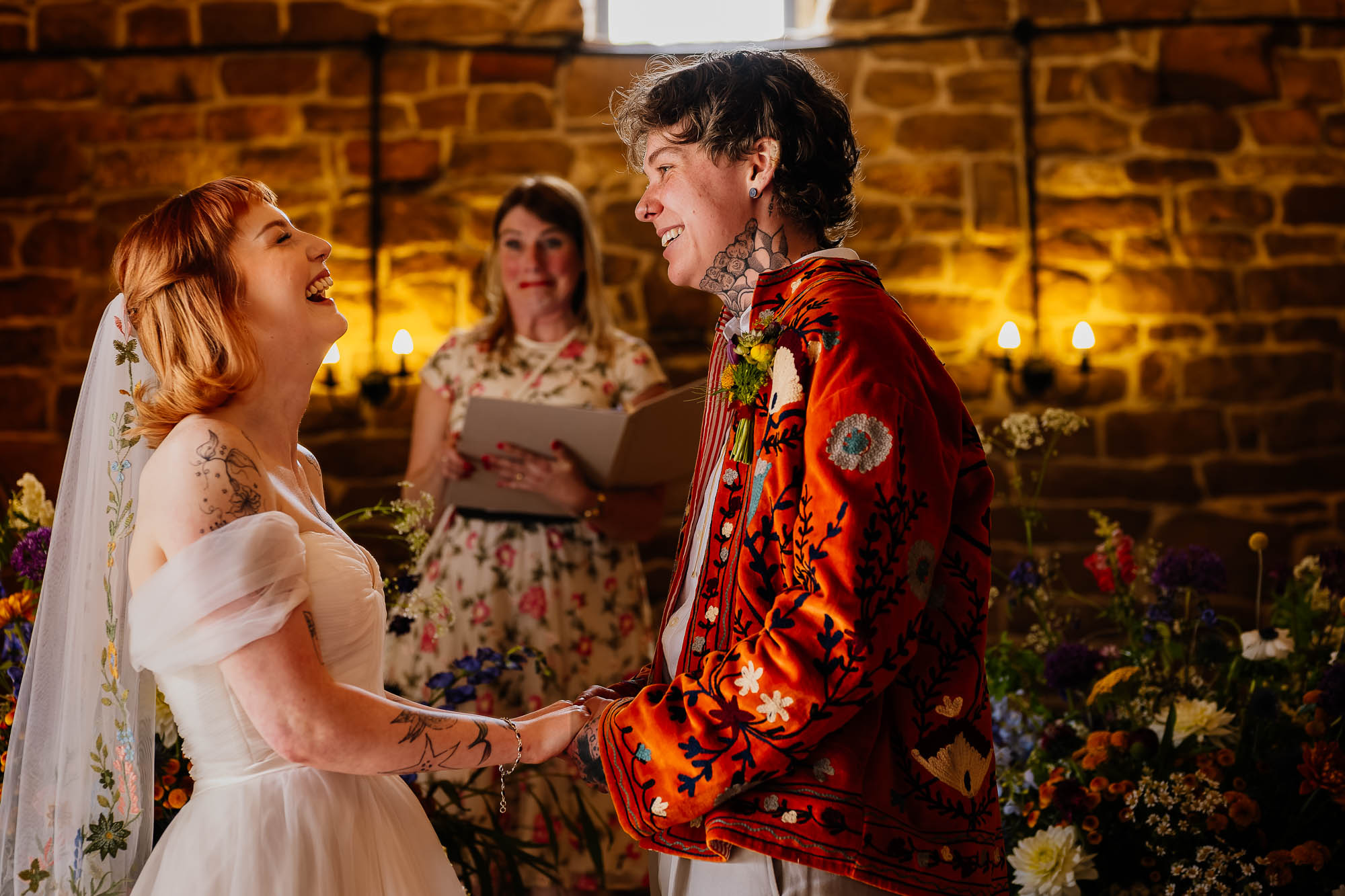 Couple laughing during wedding vows at Danby Castle