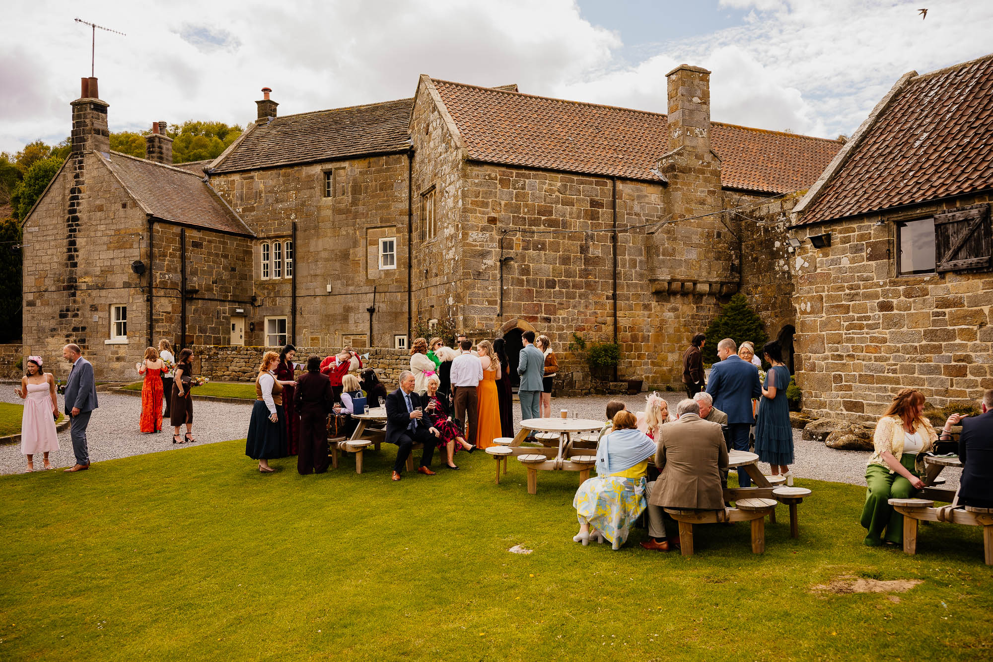 Danby Castle lawn with wedding guests spread out during reception