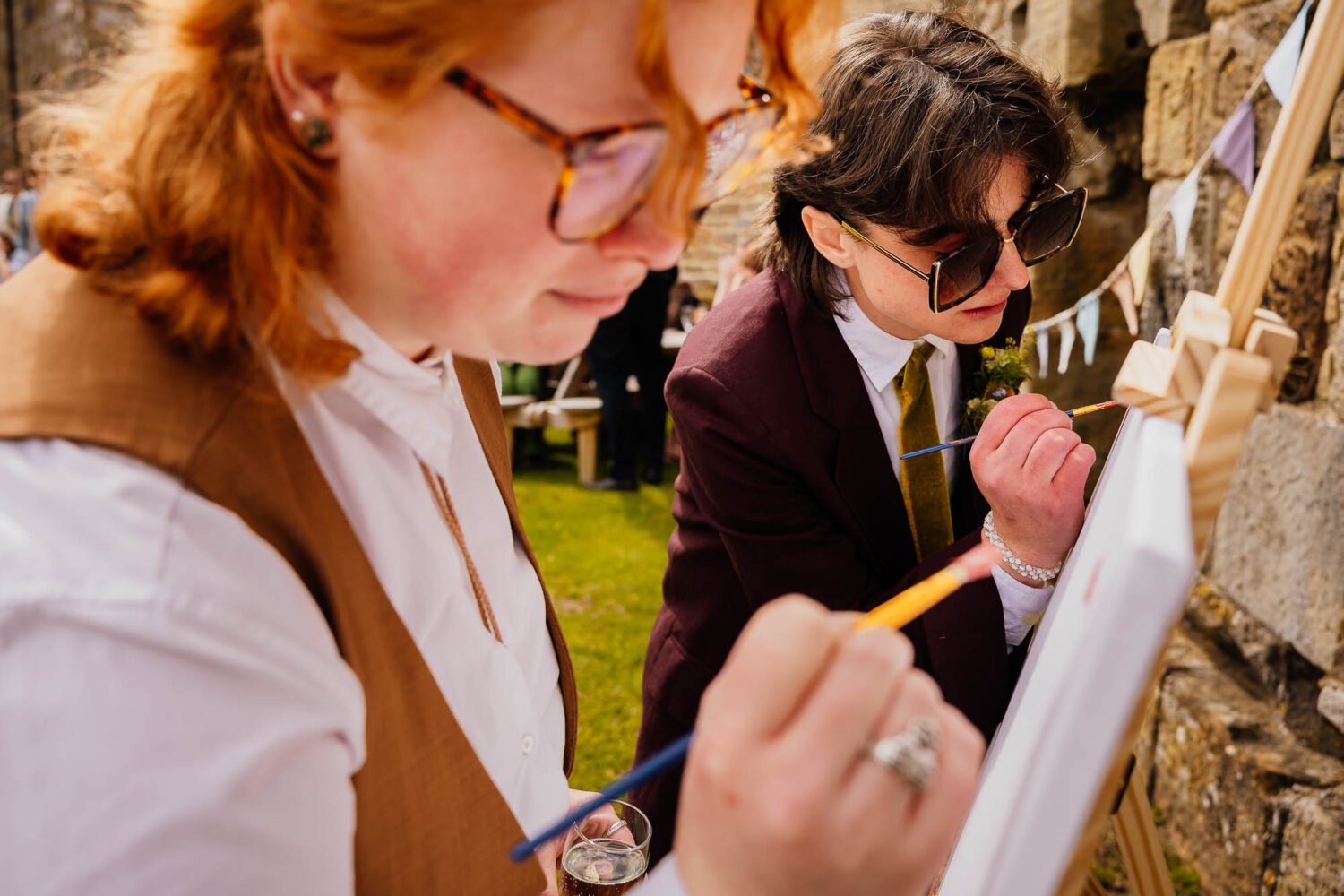 Two people painting on a canvas
