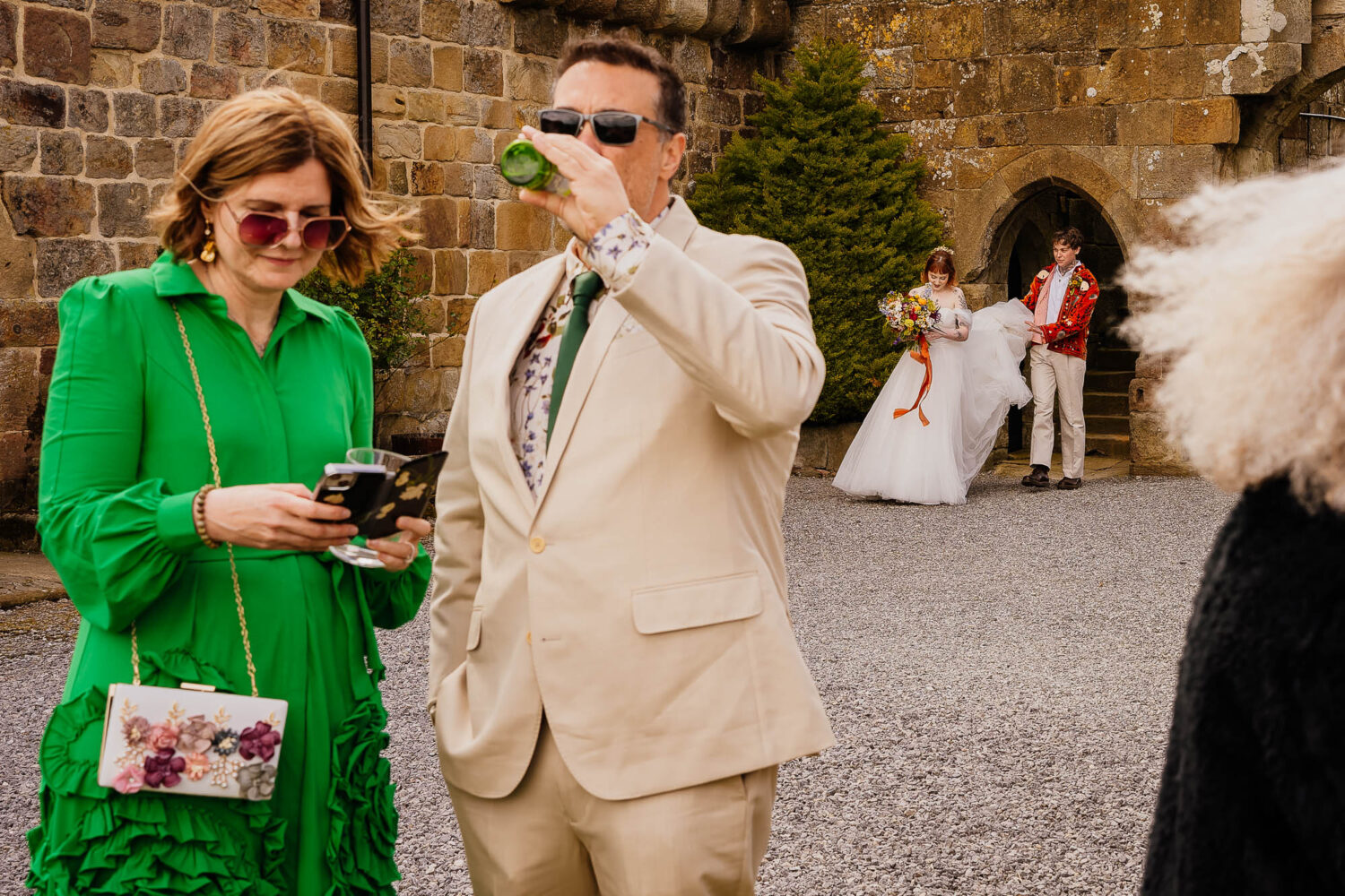 Couple entering venue with guests oblivious in the foreground
