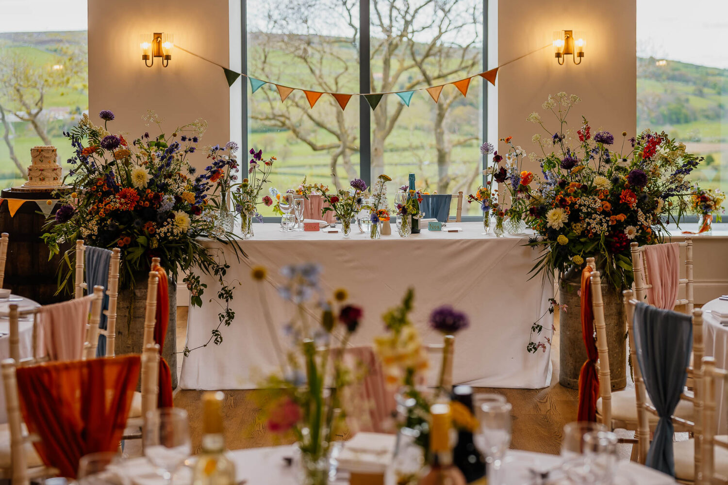 Top sweetheart table at Danby Castle wedding decorated with lots of flowers
