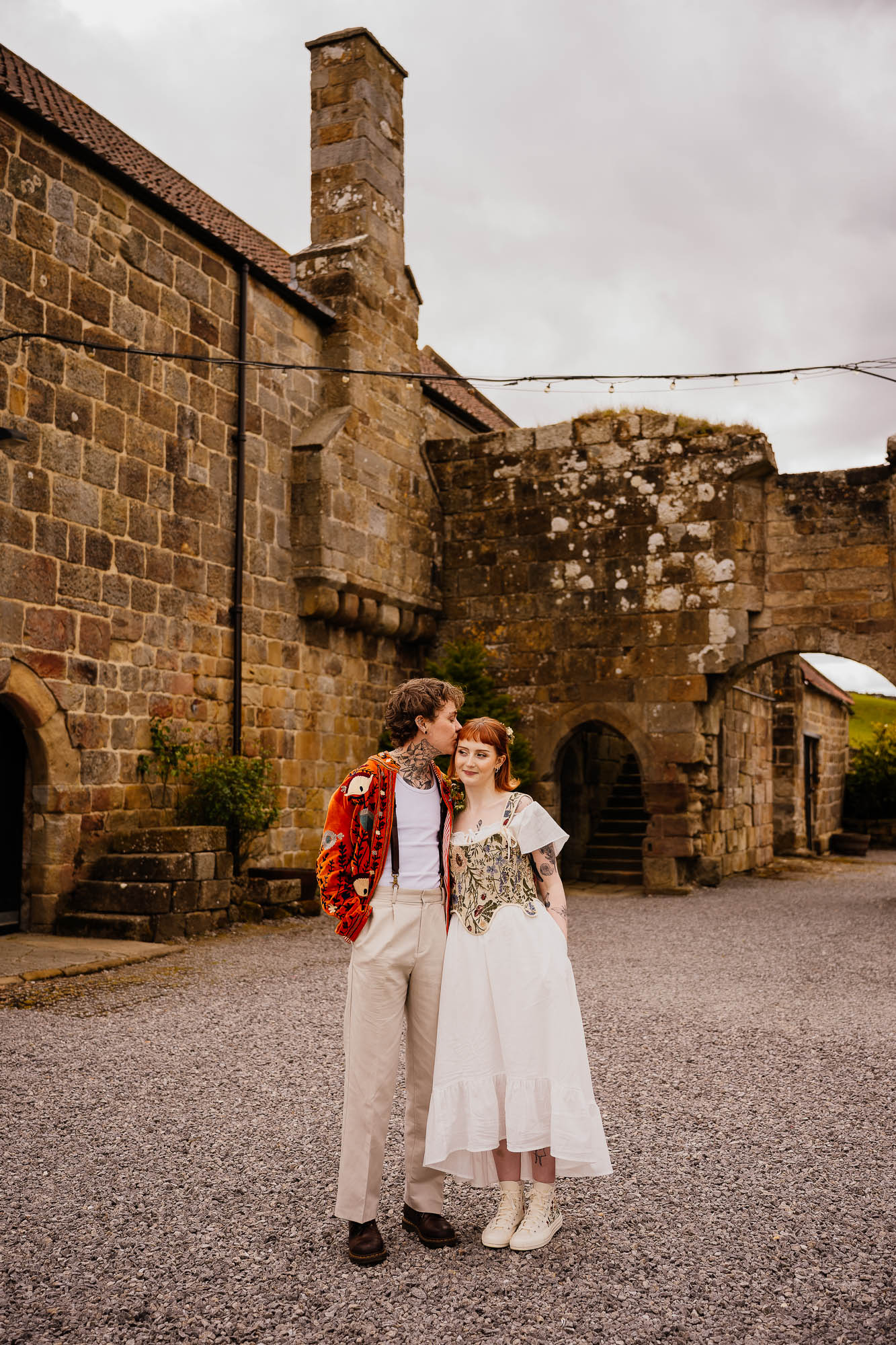 Couple kiss in front of Danby Castle barn ruins
