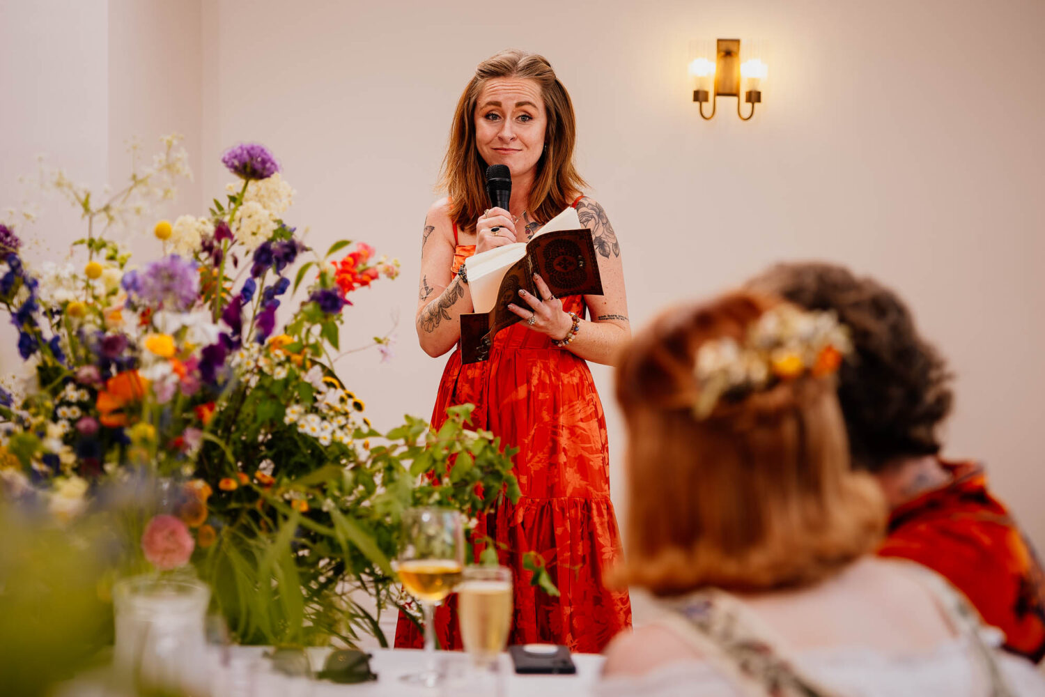 Bridesmaid speech with couple and flowers in foreground