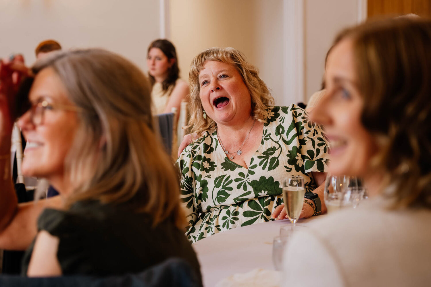 Woman laughing between two smiling women