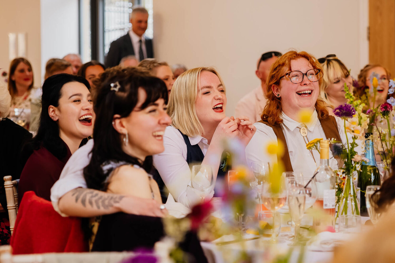 Group of friends smiling and laughing during speeches
