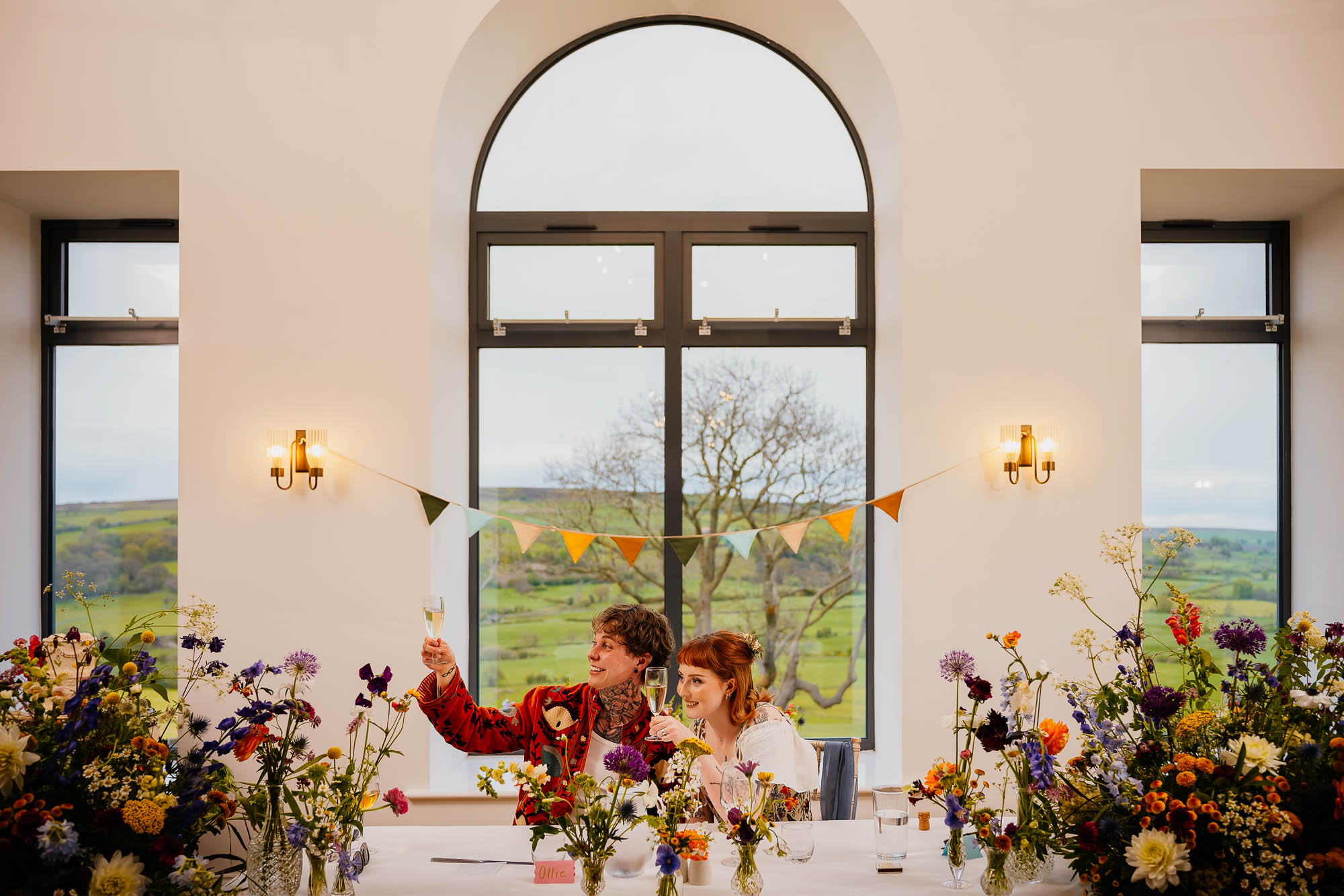 Couple cheers with prosecco under Daleview Barn windows at Danby Castle