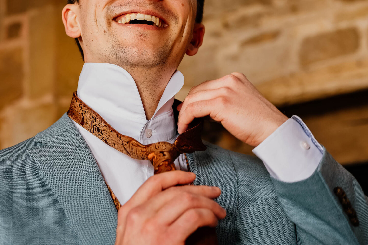 Man putting tie on over head and laughing