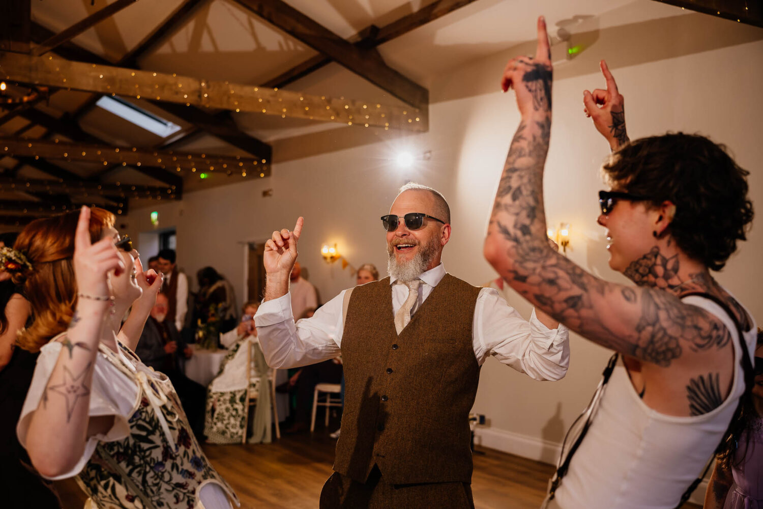Couple and dad with fingers pointed in the air