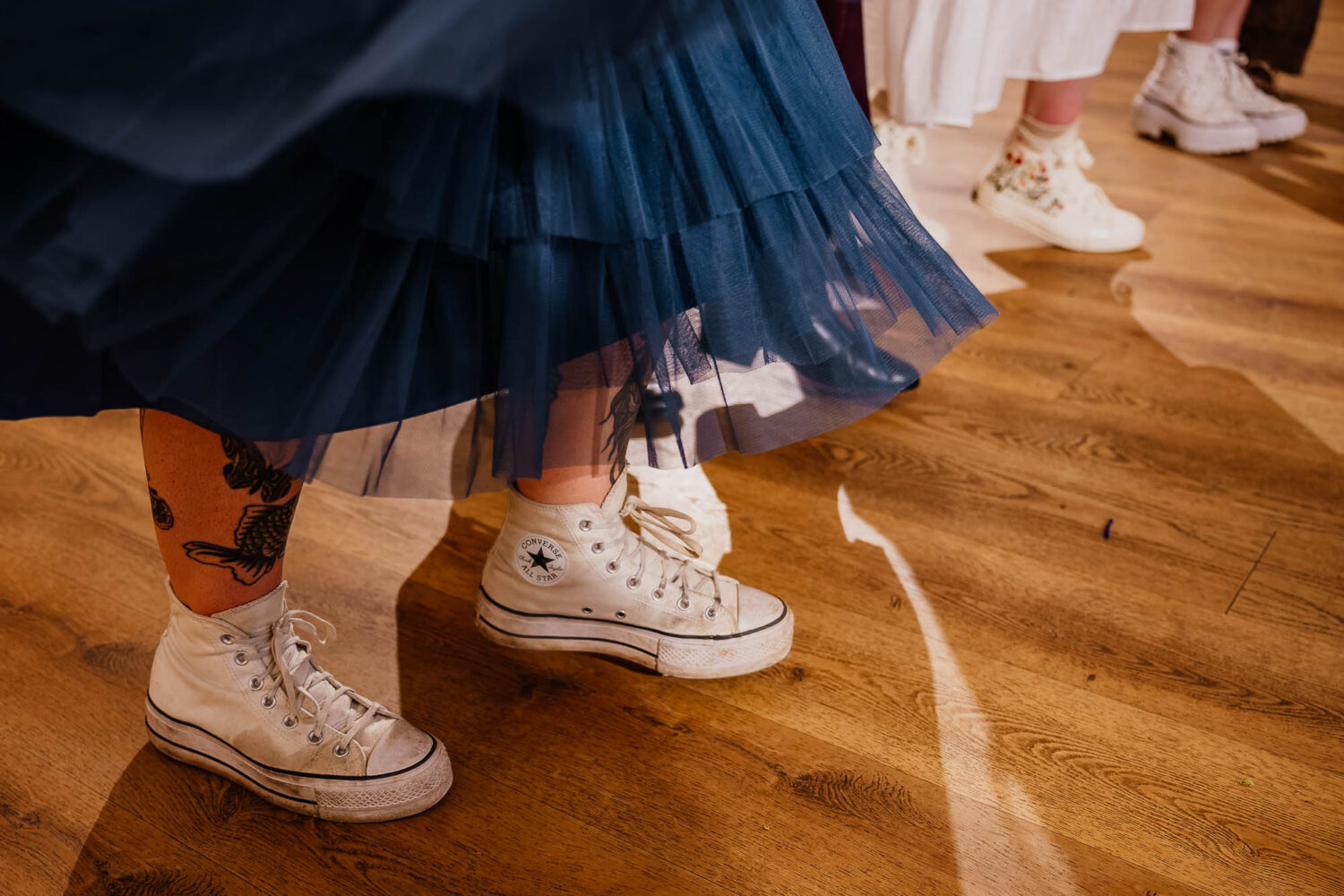 People dancing in converse with dresses flowing
