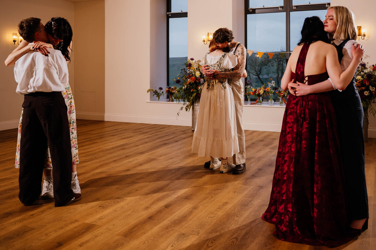 Three sets of couples dancing together at Danby Castle wedding