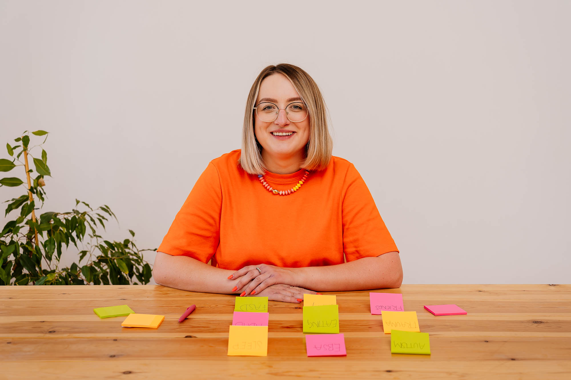 Woman smiling with post-it notes on desk