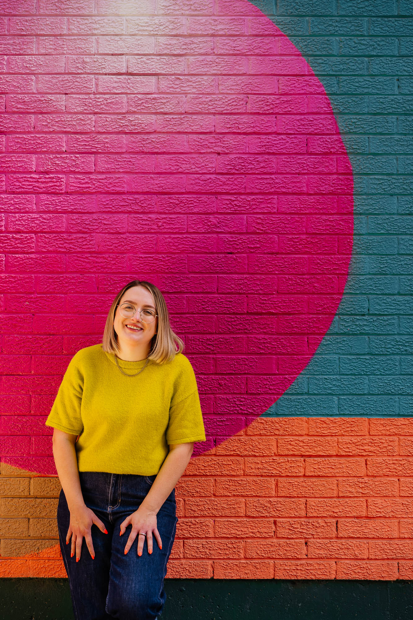Portrait of business owner against a colourful mural