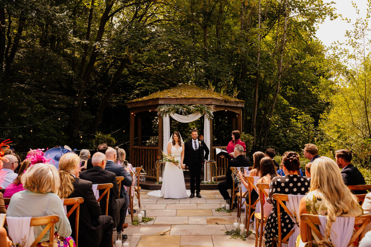 Bride and groom stood under pergola at The Venue Bowers Mill ceremony